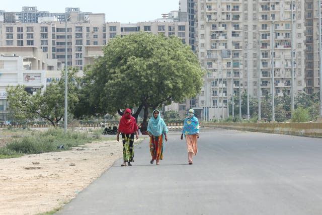 Women walk in the Noida area near New Delhi on 27 April 2020.