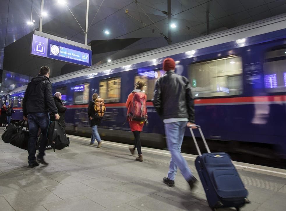 Passengers embark an Austrian sleeper train at Vienna station