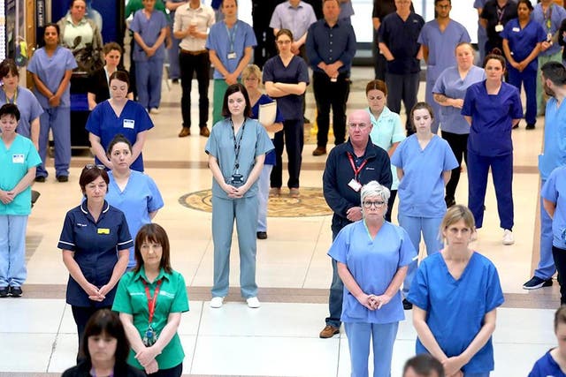 NHS staff at the Mater hospital in Belfast during a minute's silence to pay tribute to NHS and key workers who have died during the coronavirus outbreak