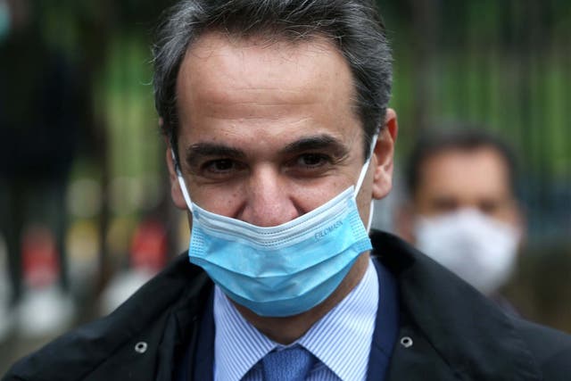 Green Prime Minister Kyriakos Mitsotakis wears a mask out in public (