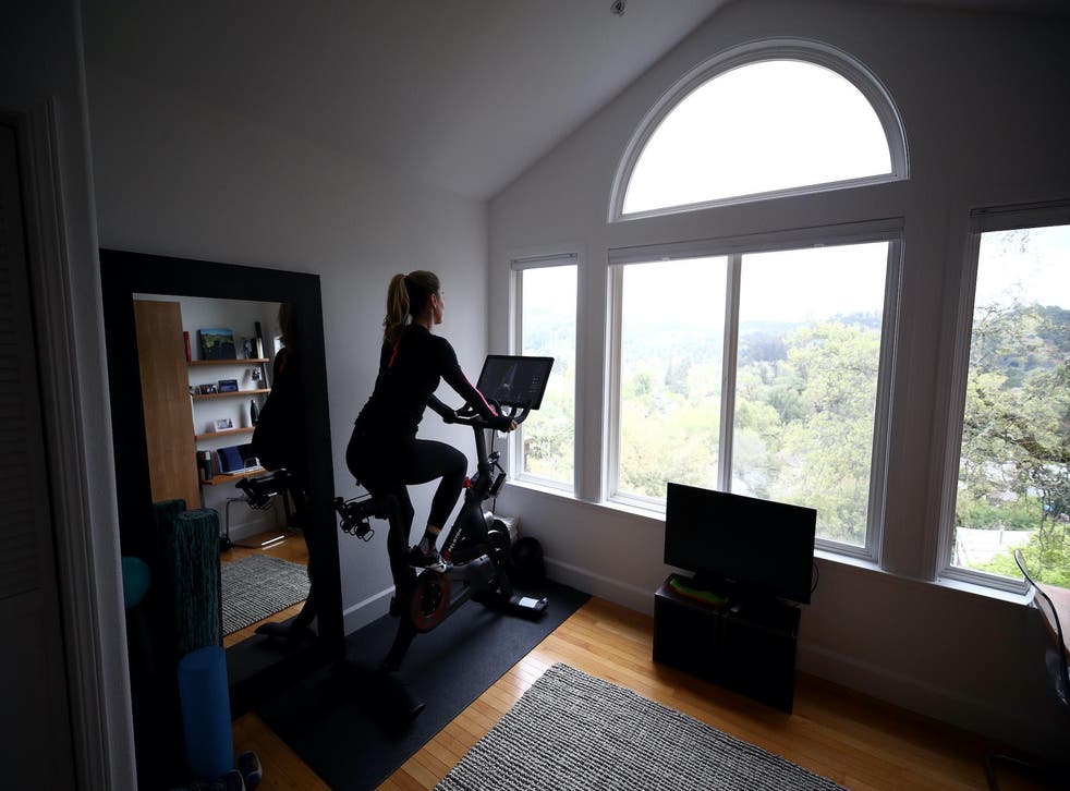 Cari Gundee rides her Peloton exercise bike at her home on April 06, 2020 in San Anselmo, California.  More people are turning to Peloton due to shelter-in-place orders because of the coronavirus (COVID-19). Peloton stock has continued to rise over recent weeks even as most of the stock market has plummeted