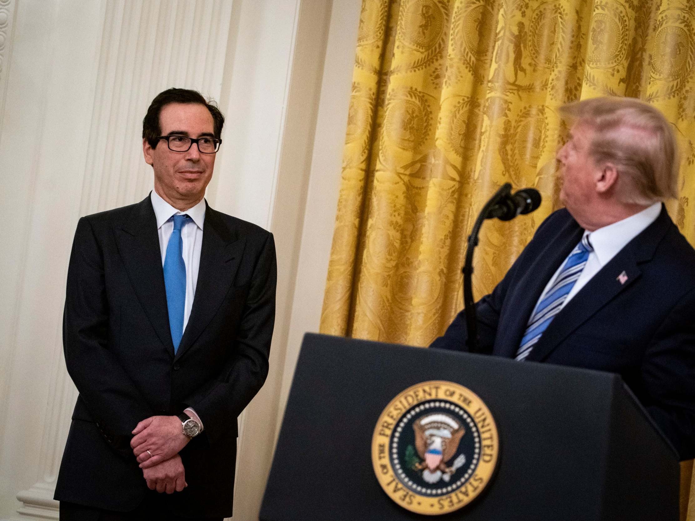Steven Mnuchin, US Treasury secretary (left), who said on Tuesday that some dead Americans had received stimulus checks