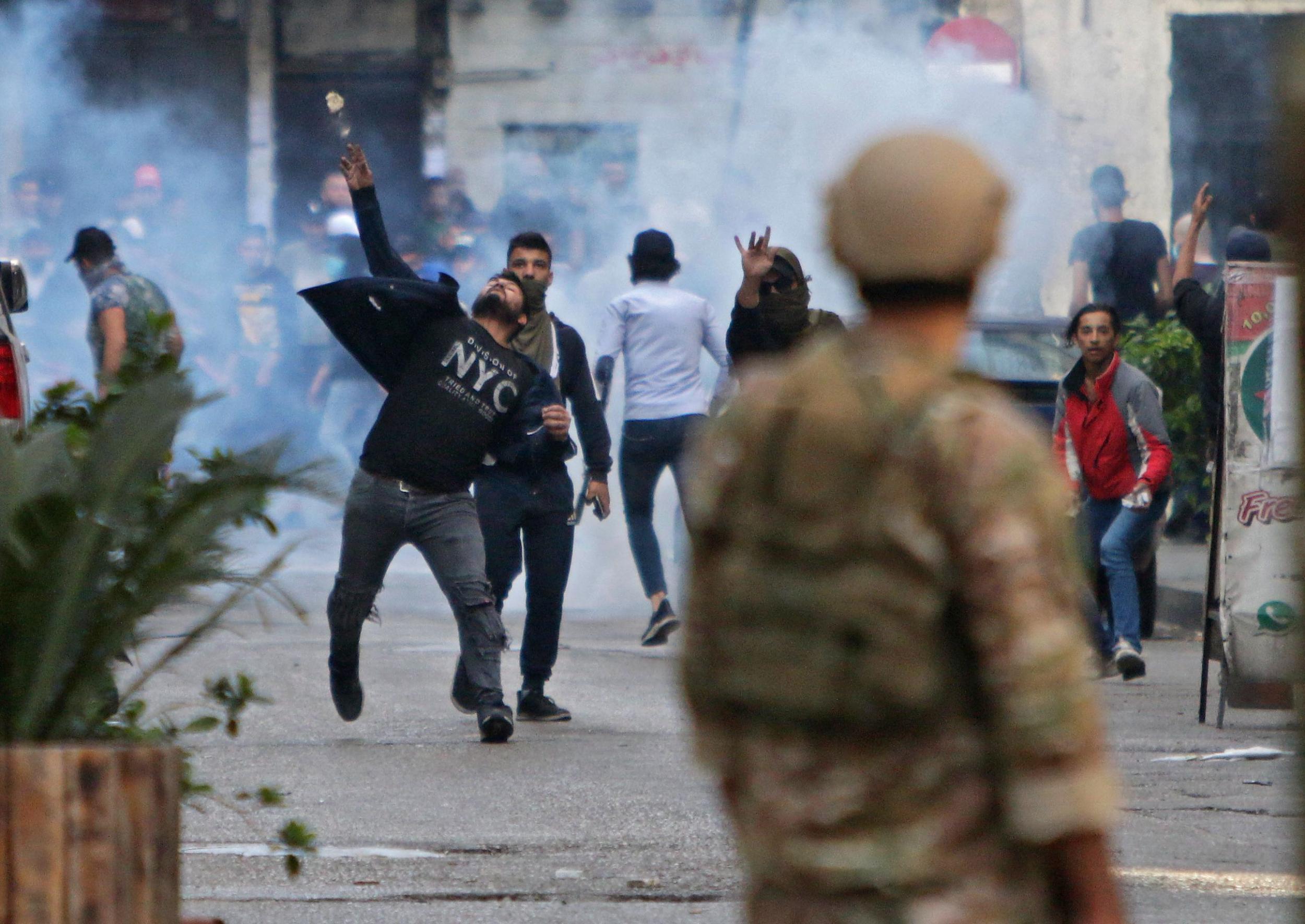 Lebanese protesters hurl rocks at soldiers in the northern port city of Tripoli on Tuesday 28 April, angry at the spiralling economic crisis