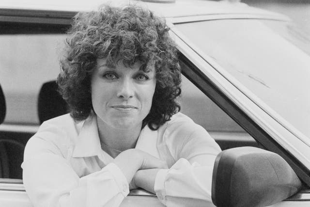 British actress and novelist Jill Gascoine sitting in the front seat of a police car, UK, 27th November 1979.