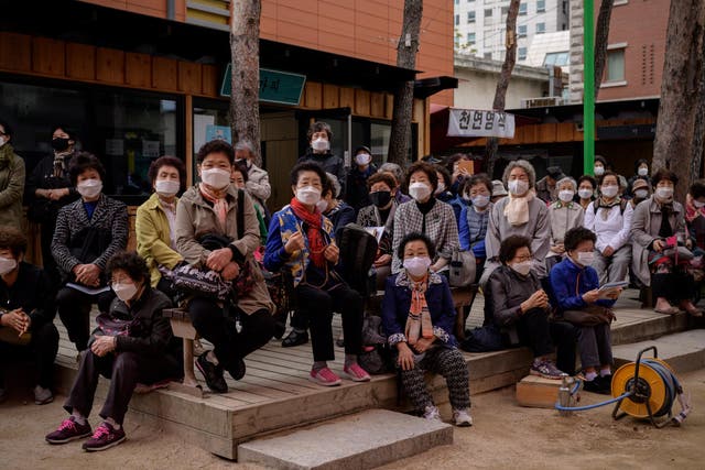South Koreans continue to protect themselves against the virus with face masks when outside