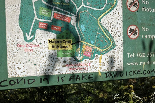 'Covid 19 is fake David Icke.com' is scrawled on an information sign at Mudchute Farm on the Isle of Dogs, east London, as the UK continues in lockdown to help curb the spread of the coronavirus