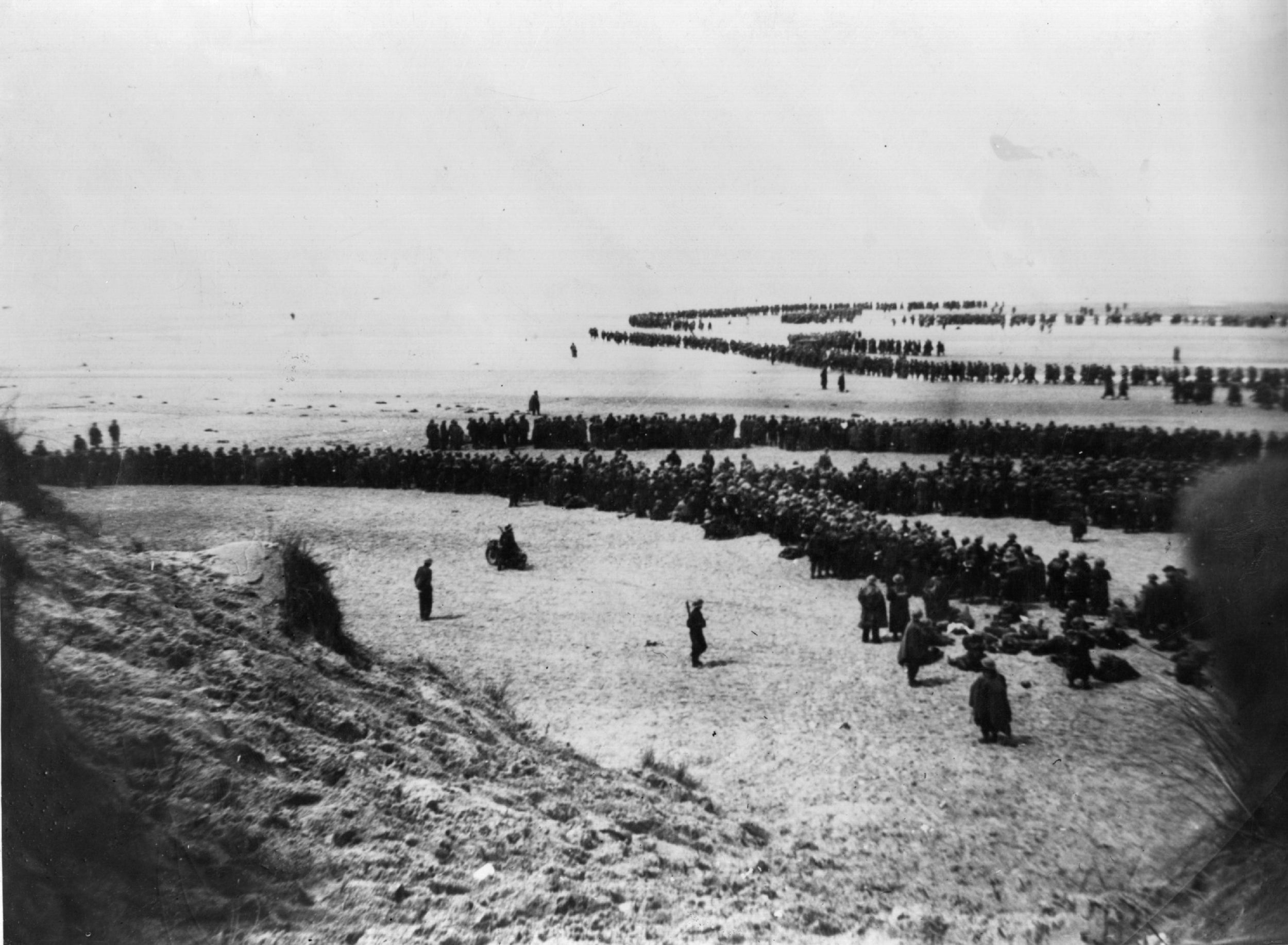 British and French troops waiting on the dunes at Dunkirk to be picked up by the Destroyers and taken back to England