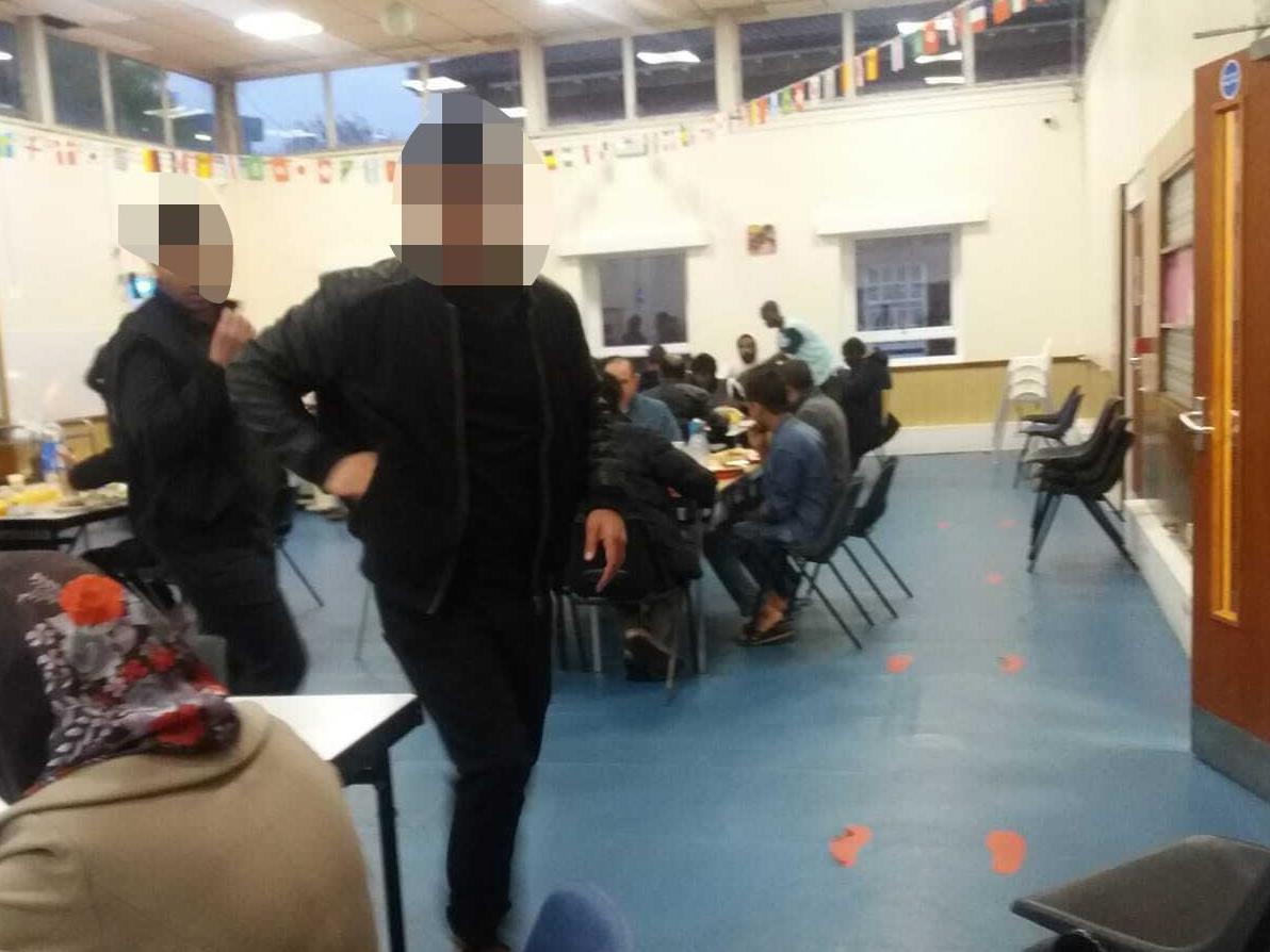 A photo taken on 28 April shows asylum seekers eating together in Urban House