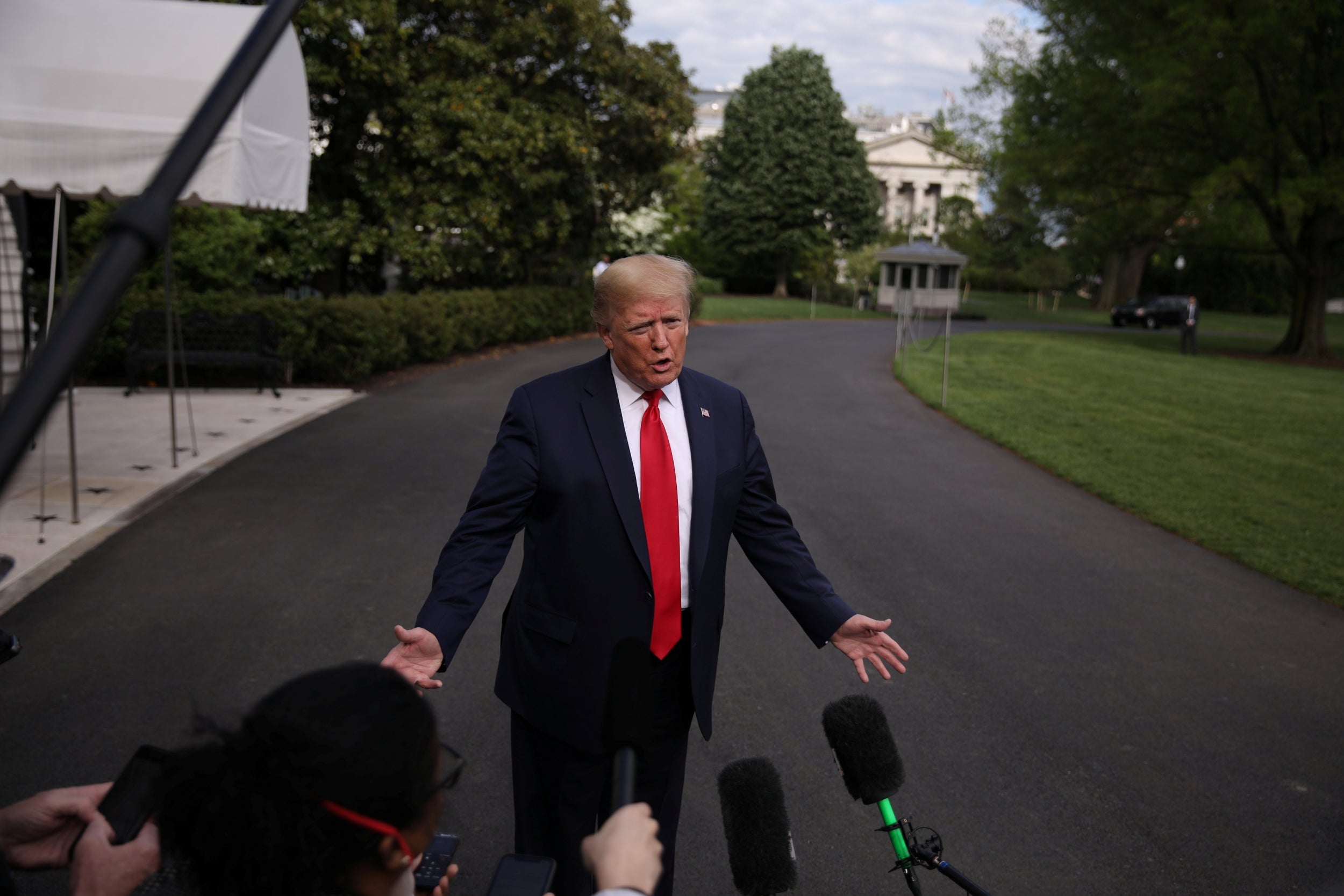 Donald Trump speaks to reporters as he leaves the White House for Camp David during the coronavirus pandemic