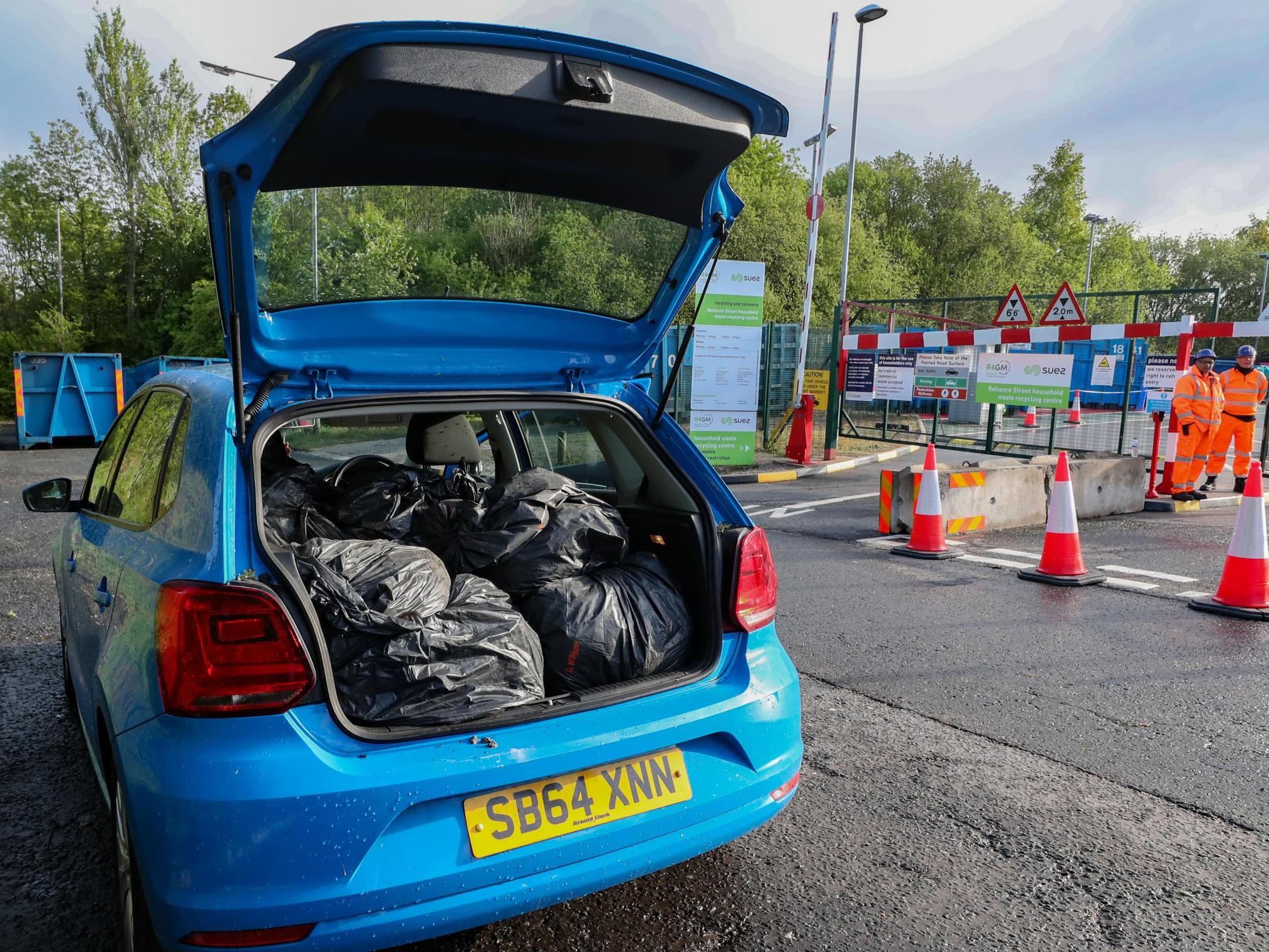 People dispose of their rubbish at a household waste recycling plant in Manchester which reopened on Saturday.