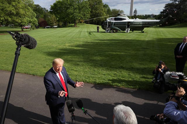 President Donald Trump talks to journalists on the South Lawn while departing the White House for Camp David on 1 May, 2020