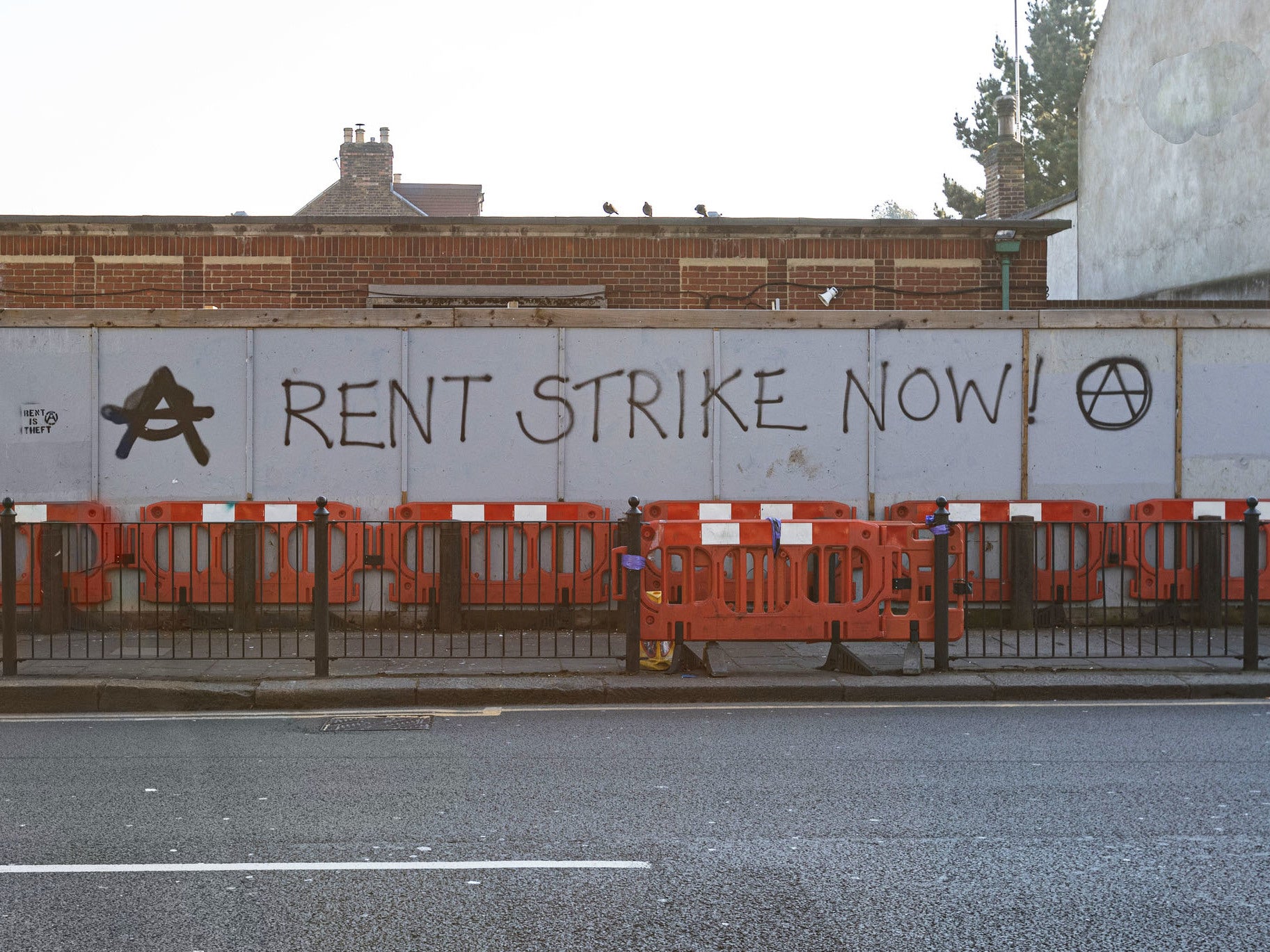 Graffiti reading ‘Rent strike now’ near Turnpike Lane station in London