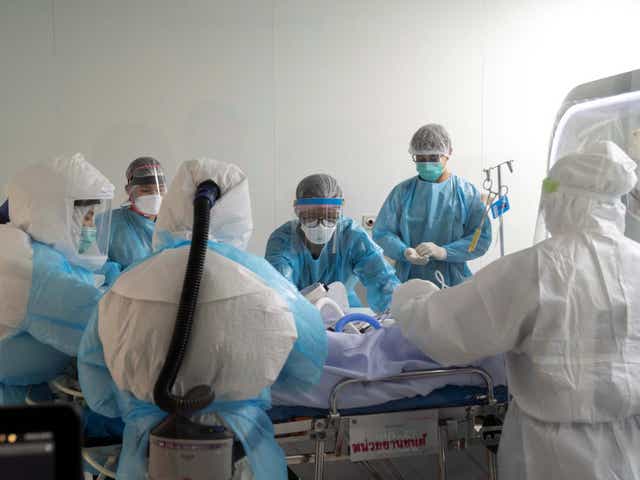 Doctors and ICU nurses wearing personal protection equipment (PPE) perform a CT scan for a Covid-19 patient