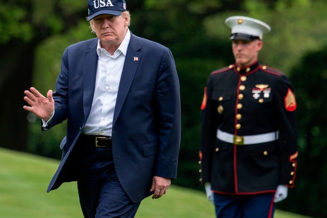 President Donald Trump waves as he walks from Marine One at the White House on 3 May
