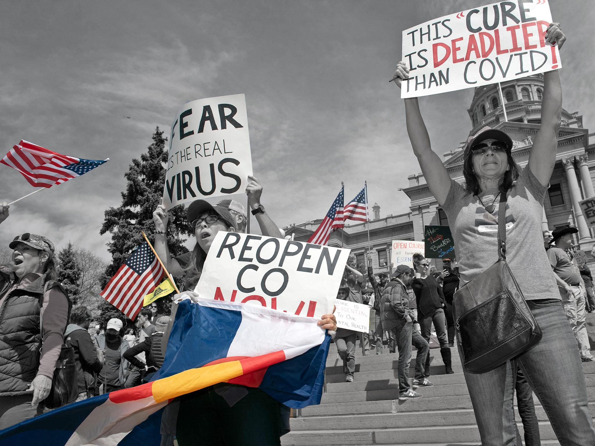 Demonstrators gather in front of the Colorado State Capitol building to protest coronavirus stay-at-home orders on 19 April