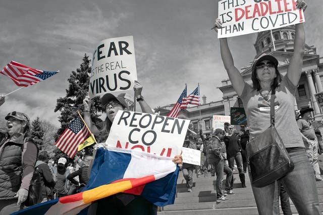 Demonstrators gather in front of the Colorado State Capitol building to protest coronavirus stay-at-home orders on 19 April