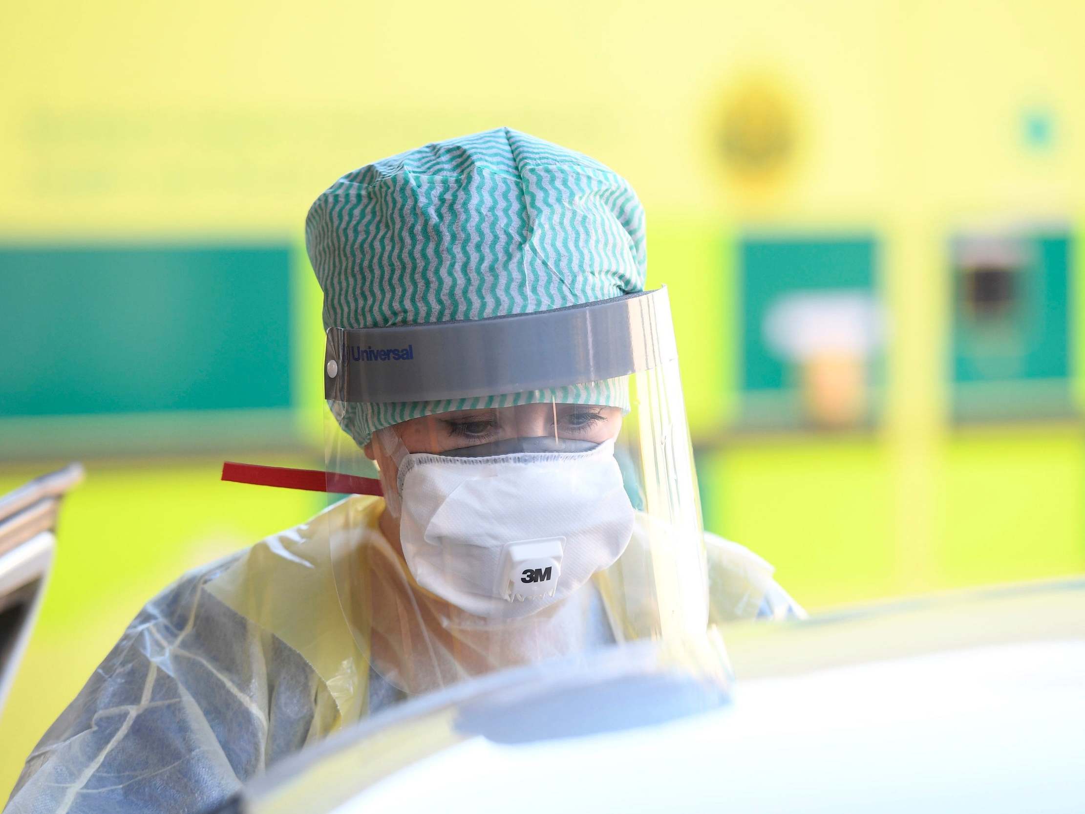 An emergency department nurse in protective clothing