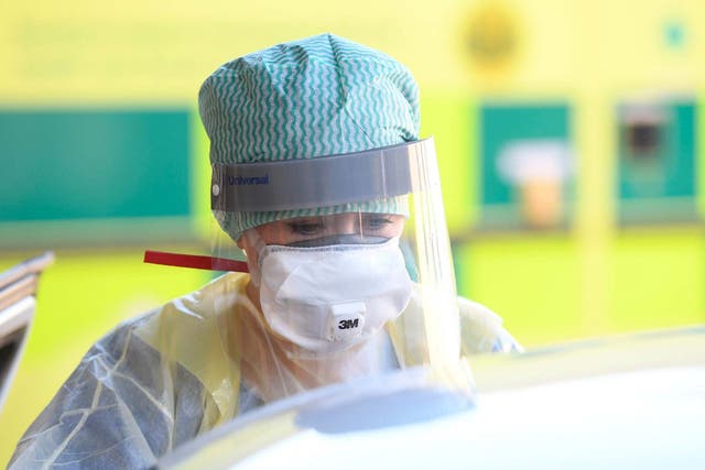 An emergency department nurse in protective clothing