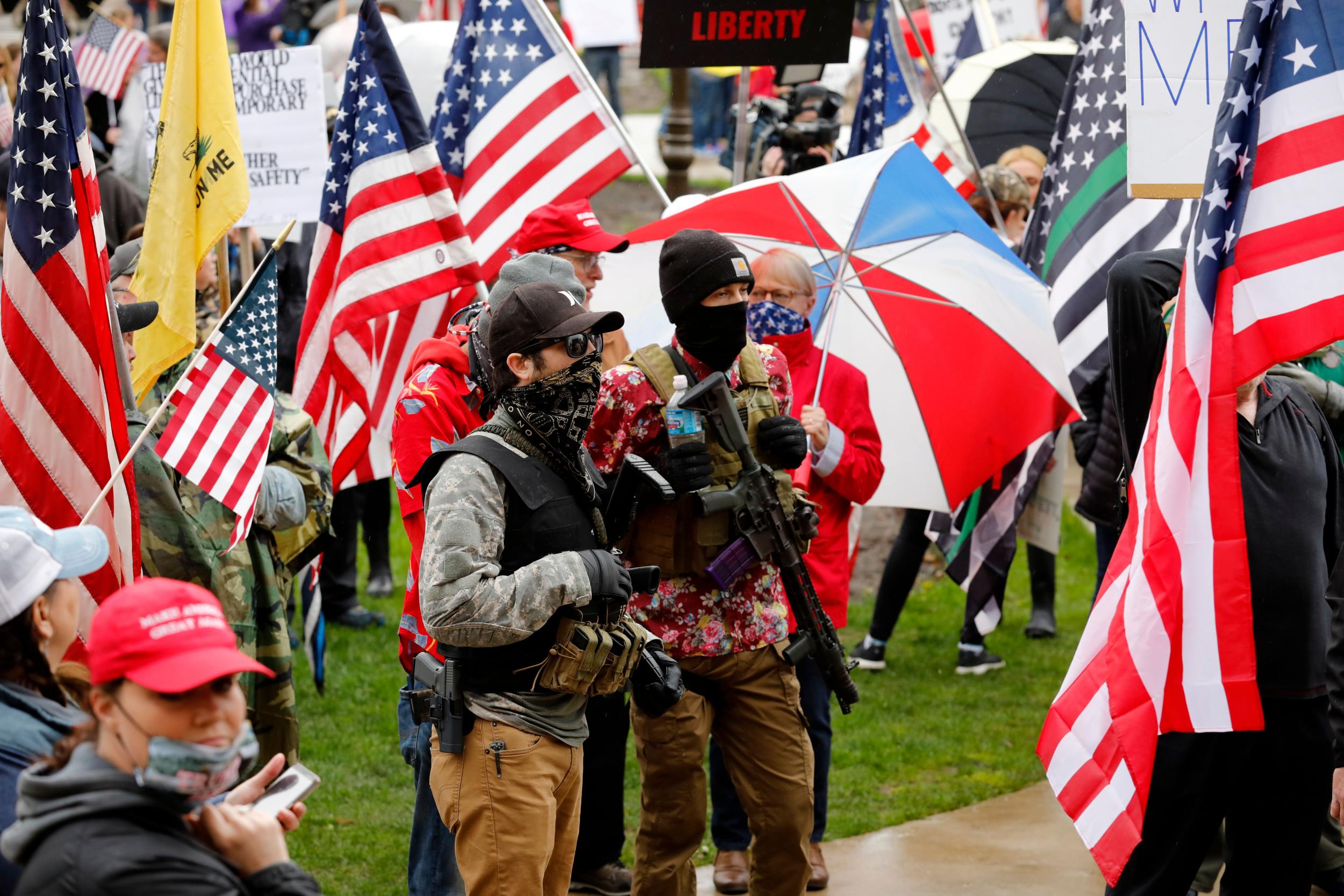 Armed protesters in Lansing, Michigan, provide security as demonstrators take part in an ‘American Patriot Rally’