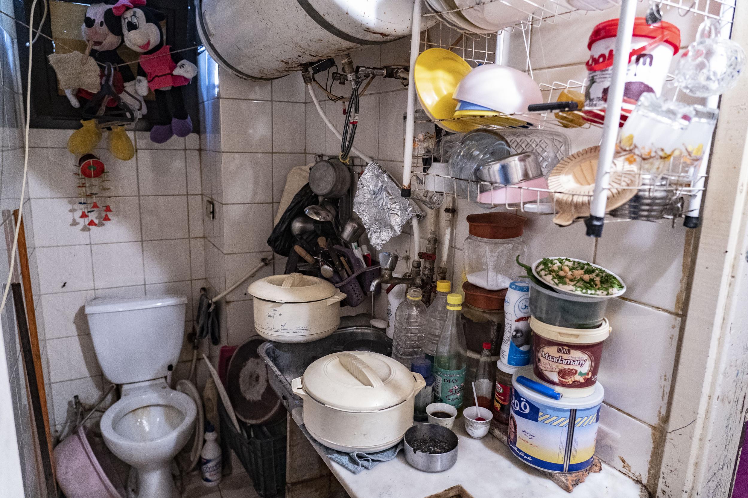 Intisar Abdel-Salem’s kitchen which is located in the bathroom, just one of two rooms where she and her four children live