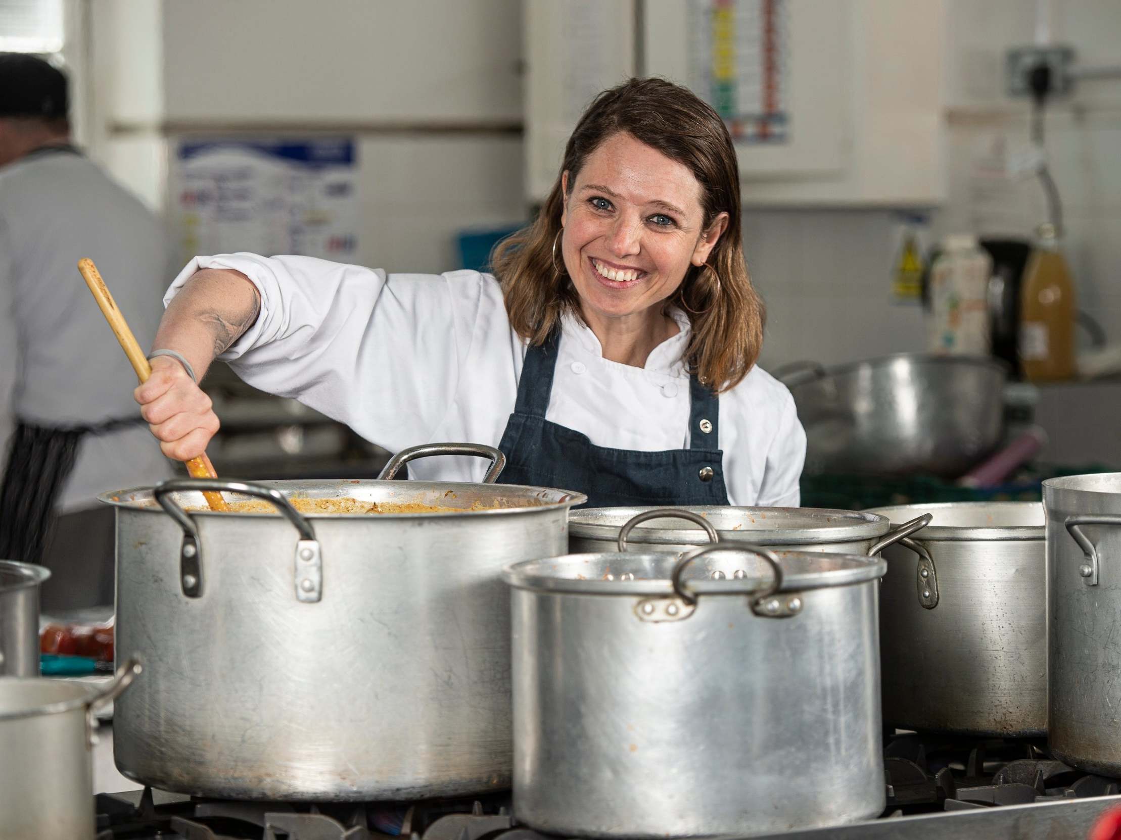 Chefs in Schools co-founder Nicole Pisani stirs up a free meal at Grasmere Primary School, Stoke Newington, north London