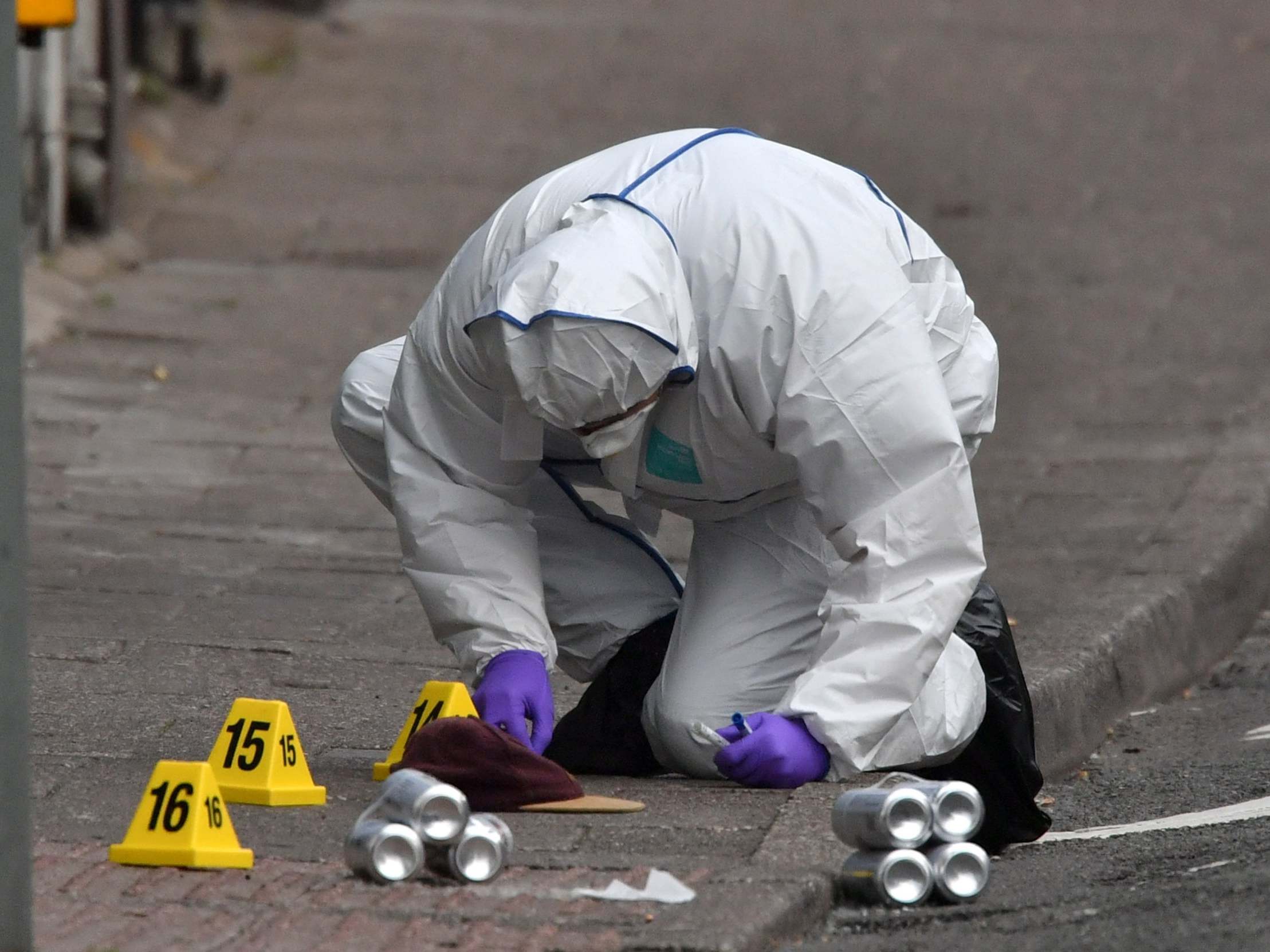 Forensic officers at the scene of a stabbing at a Co-op supermarket in the village of Pen Y Graig in South Wales, 5 May 2020.