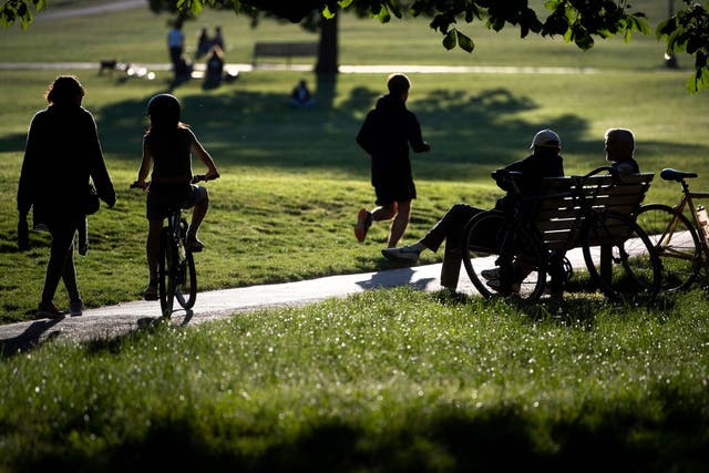 People relax and exercise in Primrose Hill park in central London, as the UK continues in lockdown to help curb the spread of the coronavirus, 6 May 2020.