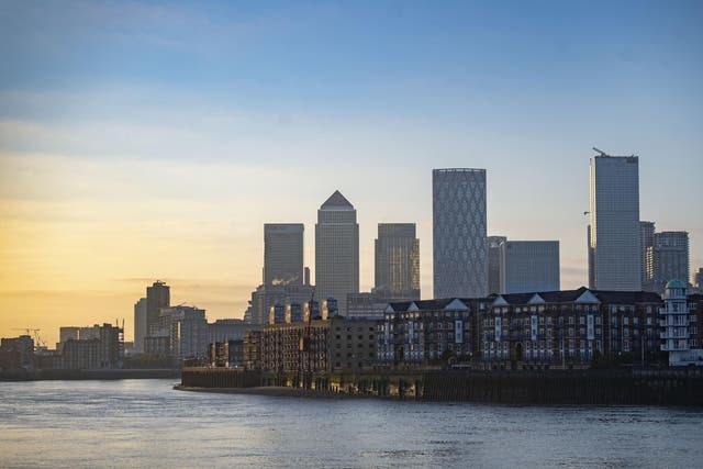 The sun rises over Canary Wharf in east London on May 6, 2020, as the UK continues its lockdown to help curb the spread of the coronavirus.