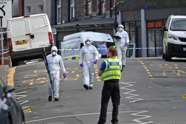 Forensic officers at the scene in Pen Y Graig in South Wales.