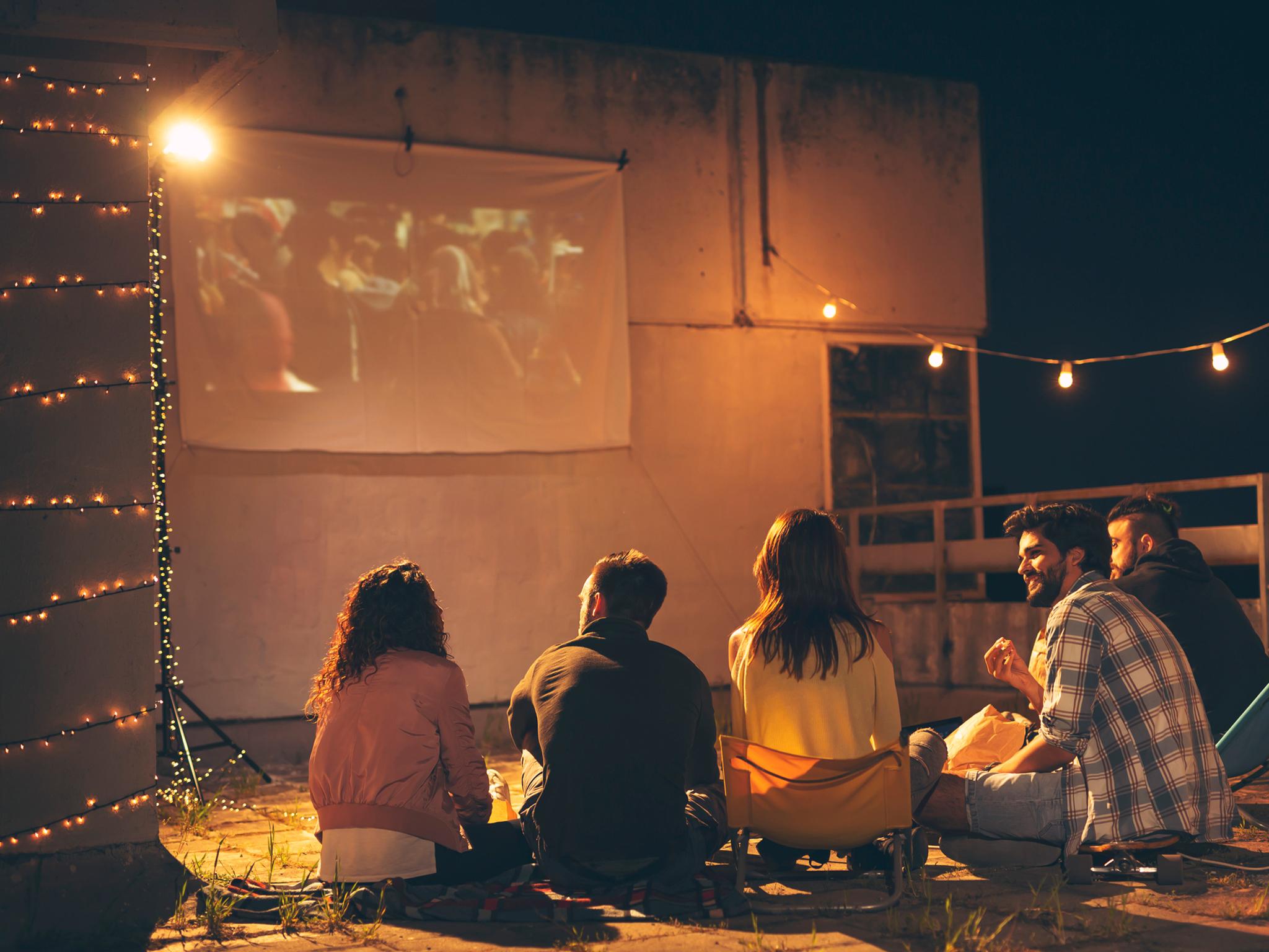 With just a plain white bed sheet and a mini projector, you can create the experience at home
