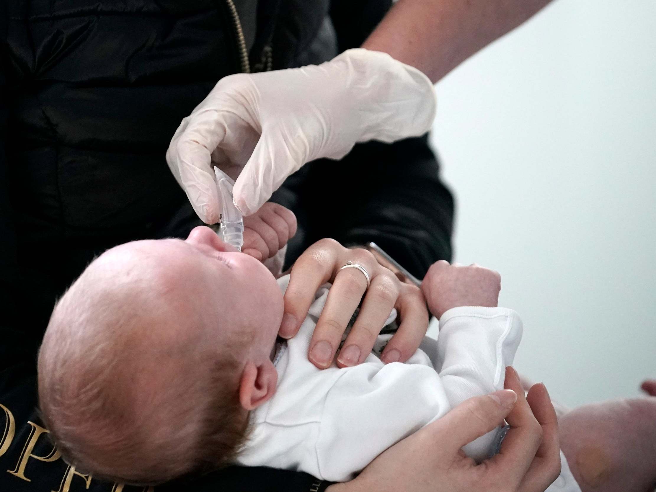 A nurse gives a baby some medicine at a UK medical centre. Globally, 116 million births are expected in the nine months since the pandemic was declared