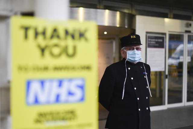 A Chelsea pensioner stands outside the Chelsea and Westminster Hospital last week wearing a protective mask due to the coronavirus outbreak.