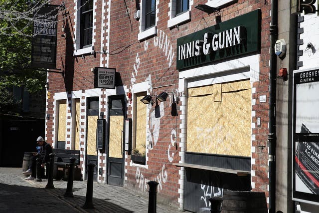 A view of boarded up restaurants and pubs in Ashton Lane in Glasgow as the UK continues in lockdown to help curb the spread of the coronavirus