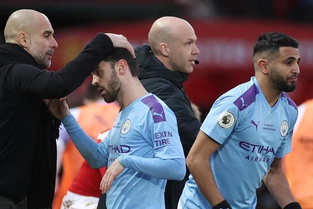 Manchester City's Bernardo Silva with manager Pep Guardiola as he is substituted