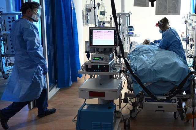 Clinical staff wear personal protective equipment (PPE) as they care for a patient at the intensive care unit at the Royal Papworth Hospital in Cambridge, 5 May 2020.