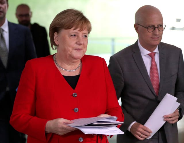 German Chancellor Angela Merkel alongside Peter Tschentscher, Mayor of Hamburg, at a news conference on reducing coronavirus restrictions