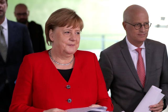 German Chancellor Angela Merkel alongside Peter Tschentscher, Mayor of Hamburg, at a news conference on reducing coronavirus restrictions