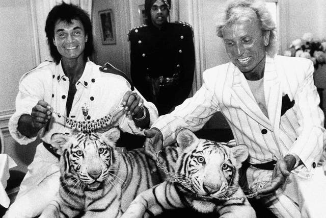 Roy Horn, left, and Siegfried Fischbacher pose in New York, with their rare white tigers, Neva, left, and Vegas. Taken in June 1987