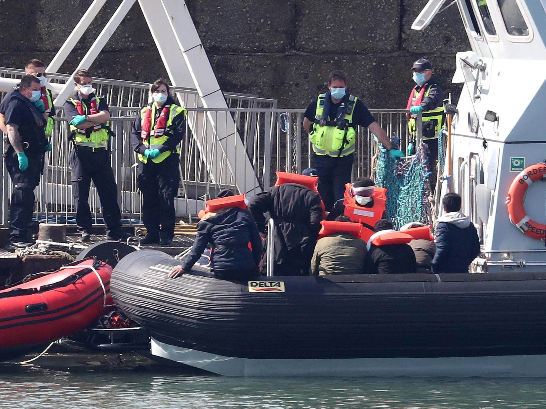 Border Force officers prepare to bring to shore men thought to be migrants in Dover on 9 May