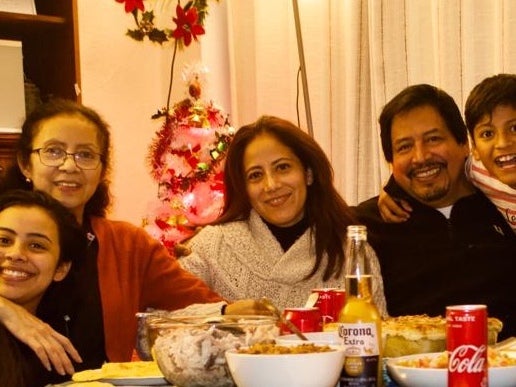 Jose de Jesus Vasquez (second to right) sits at the dinner table with (from left to right) daughter Aylin, his wife Martha (second left), eldest daughter Janeth and his nephew Jorge