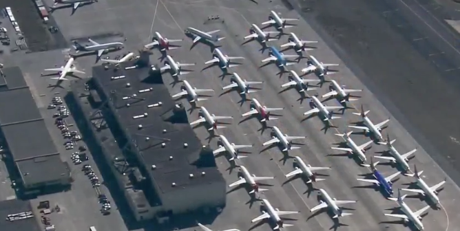 Dozens of aircraft parked at an airport as airlines suspend routes and passenger numbers plummet due to the coronavirus pandemic