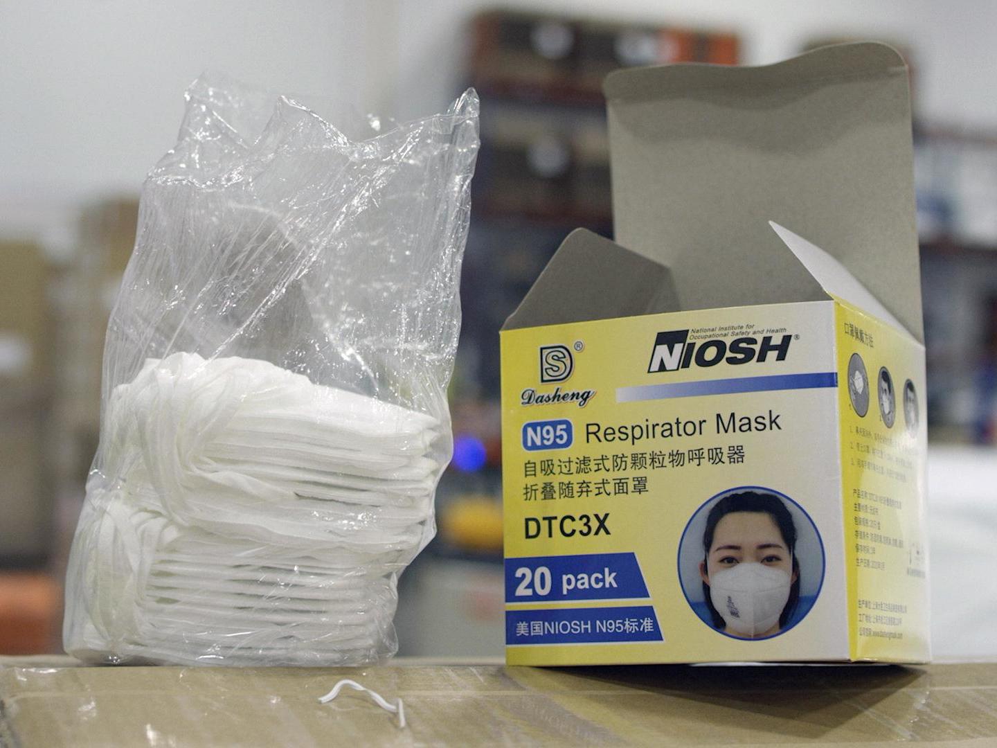 An opened box of protective masks sits on a pallet at Direct Relief's distribution center in Santa Barbara, California