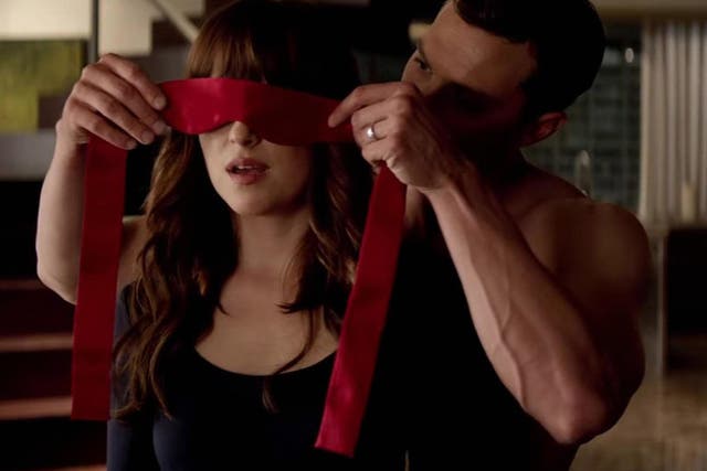Christian Grey puts Ana Steele in a blindfold in Fifty Shades of Grey.