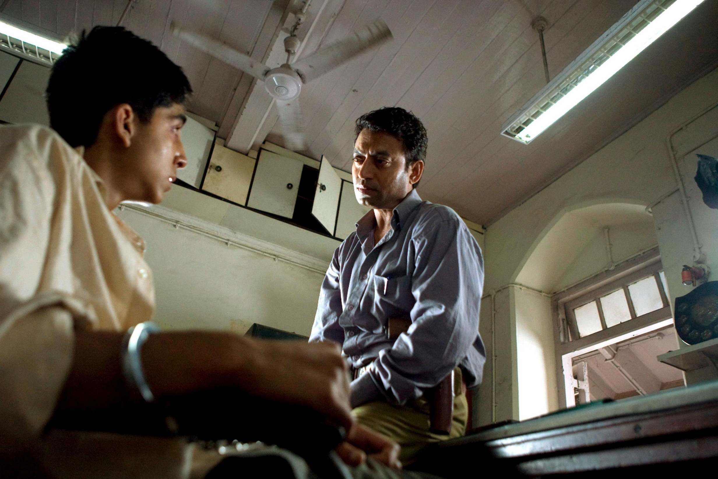 Khan as the detective interviewing Dev Patel’s TV quiz show winner in ‘Slumdog Millionaire’