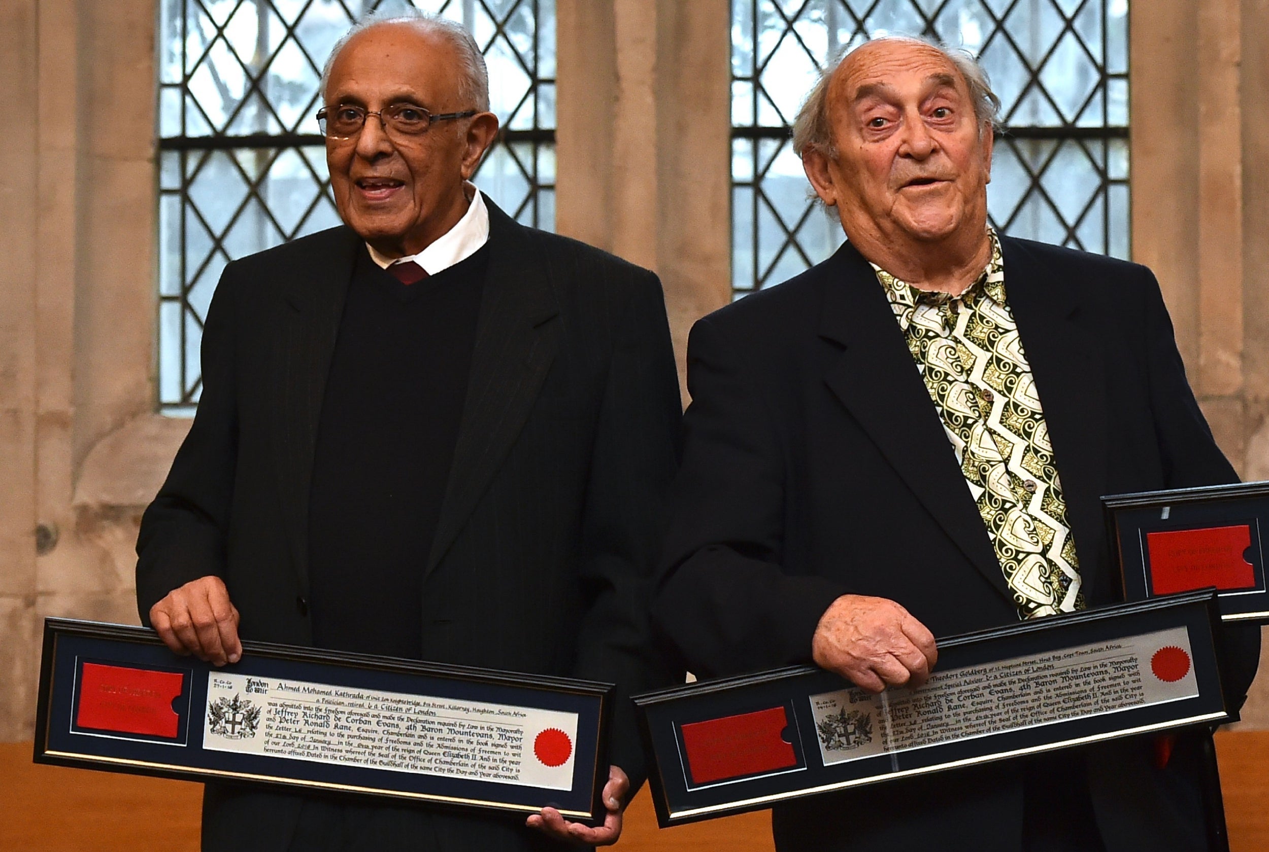 Goldberg alongside South African politician Ahmed Kathrada (left) holding certificates of their award of the Freedom of the City of London at the Guildhall on 27 January 2016