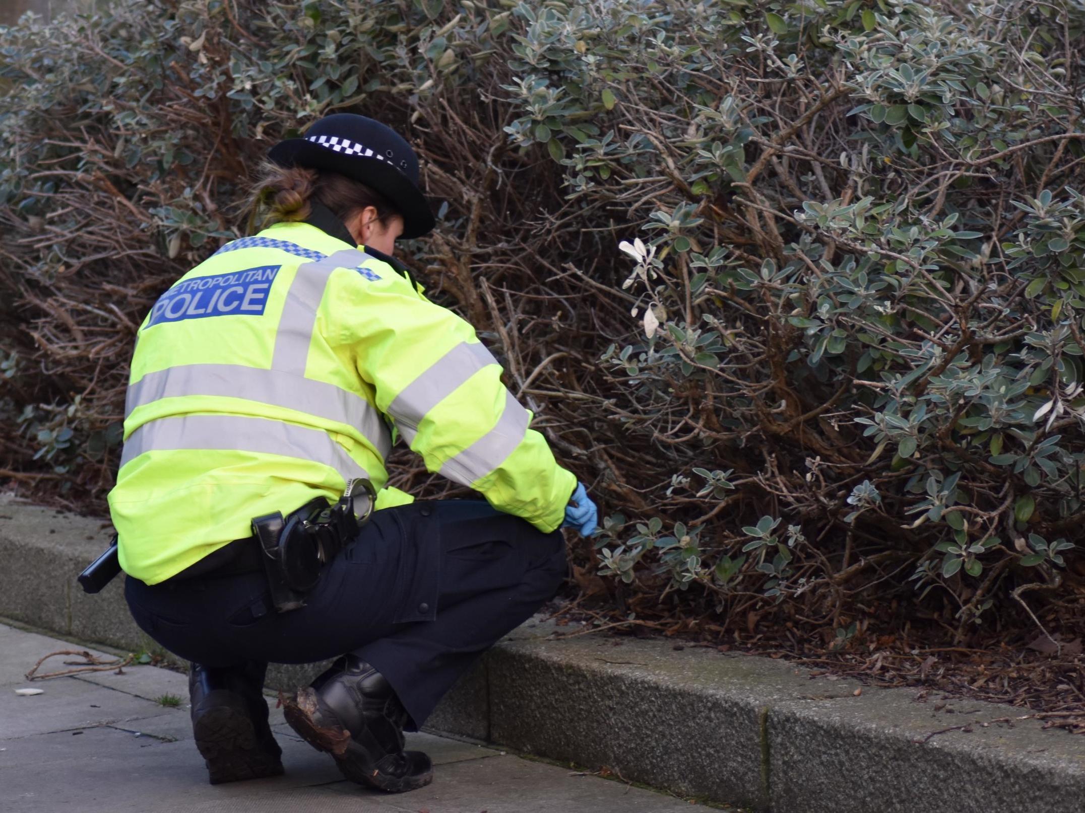 A Metropolitan Police officer searching for hidden weapons during a week of action at the start of the UK's coronavirus lockdown in March