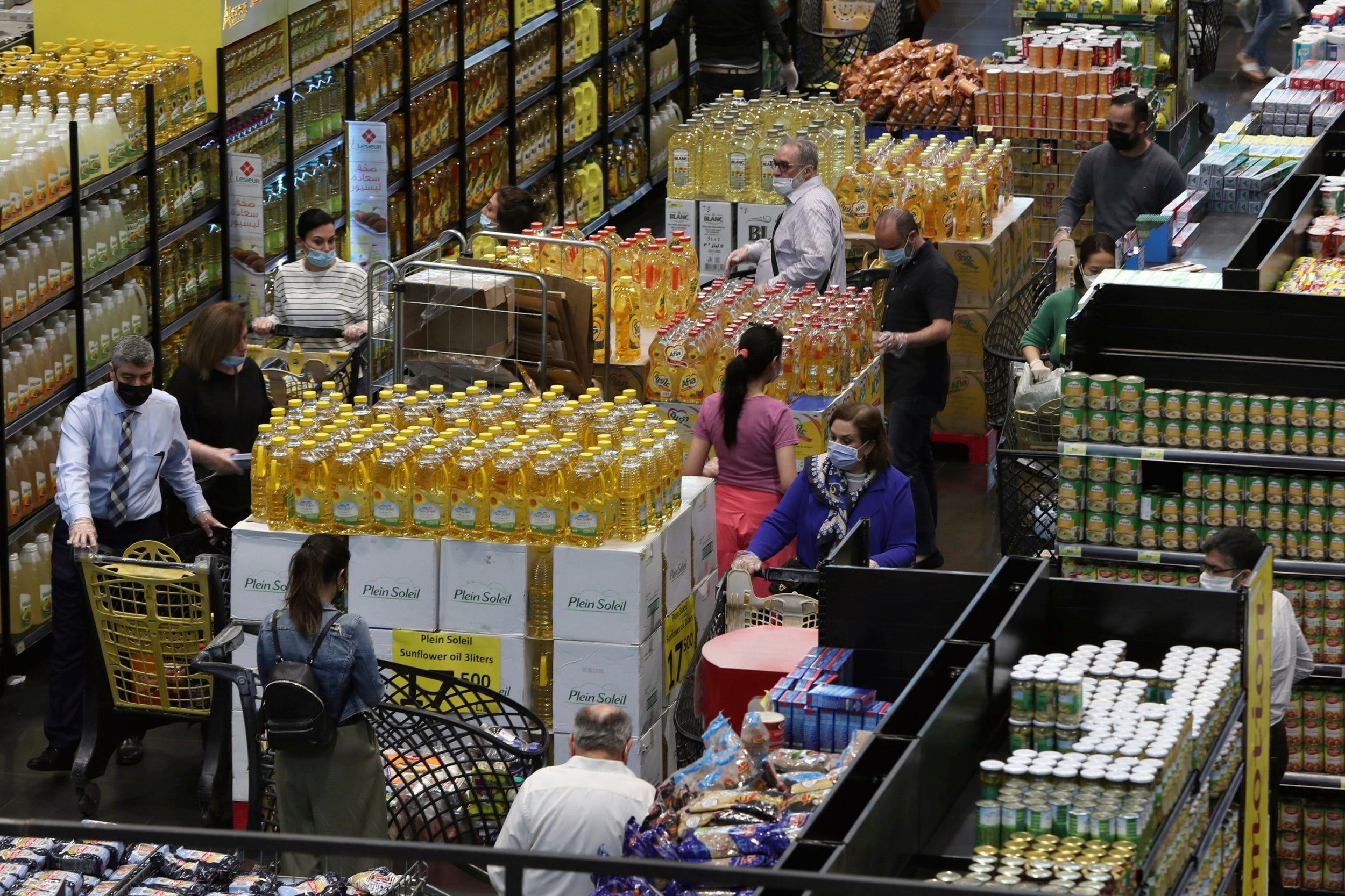 People shop at a supermarket as they begin to stock up on provisions in Beirut, Lebanon