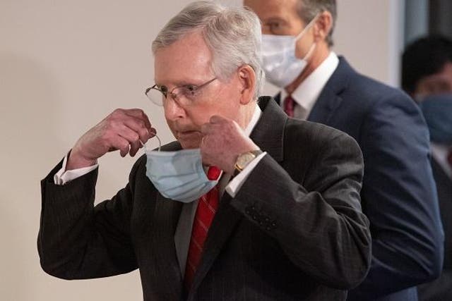 Senate Majority Leader Mitch McConnell dons a mask amid the coronavirus outbreak. AFP via Getty Images
