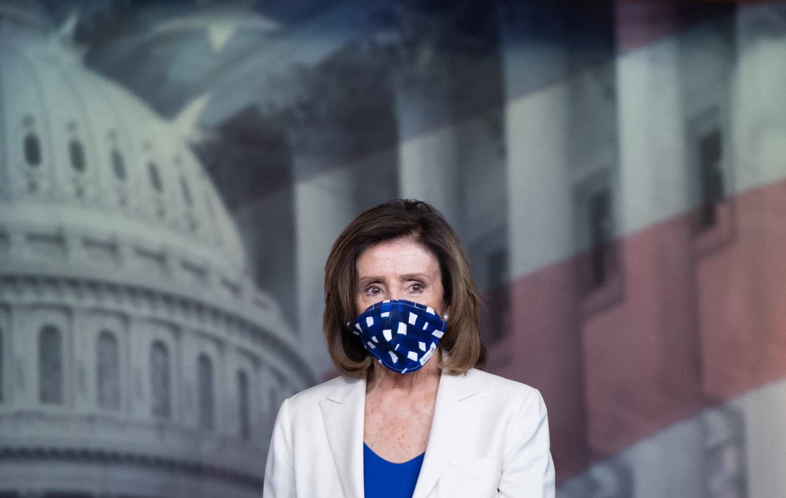 Pelosi wears a blue and white mask (Getty)