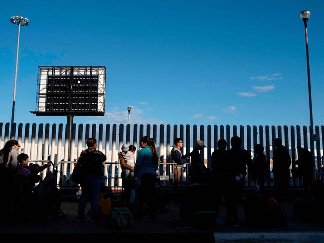 Asylum seekers wait for their turn to cross from Mexico into the United States in Tijuana, on 29 February 2020